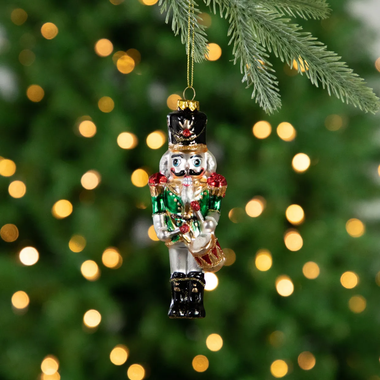 5.25" Green, Red and Gold Nutcracker With Drum Glass Christmas Ornament